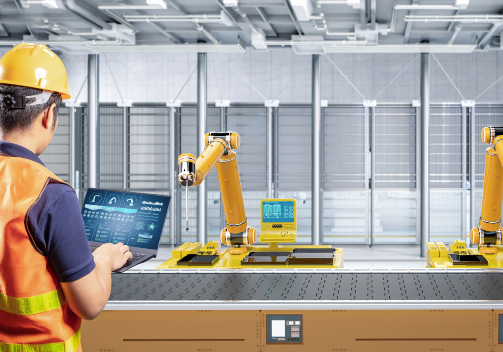 smart factory worker overlooking robotic arms